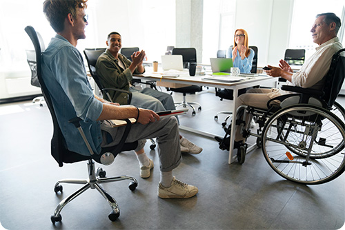 Man in wheelchair having office job